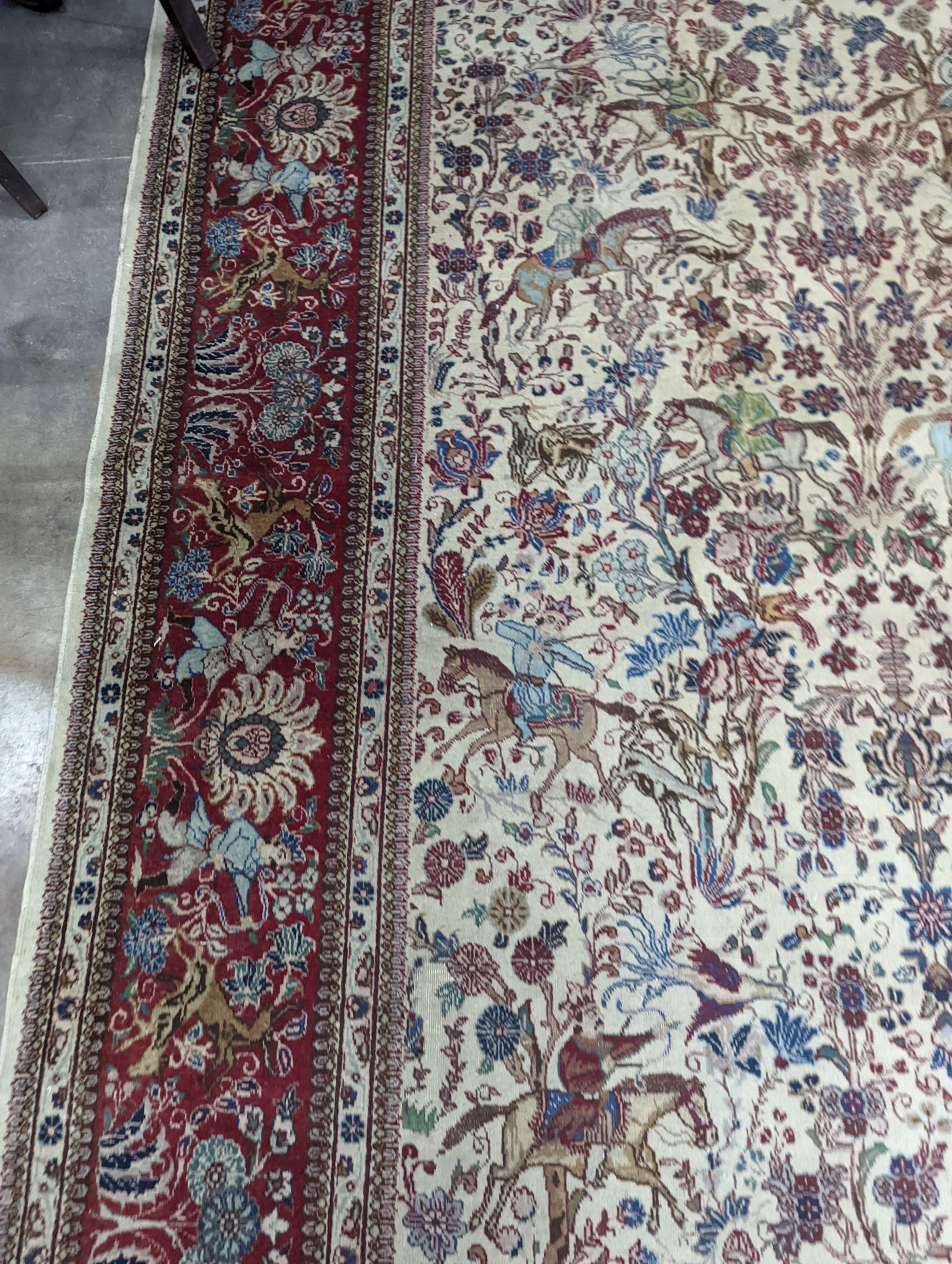 A Tabriz ivory ground pictorial rug (signed), 390 x 294cm